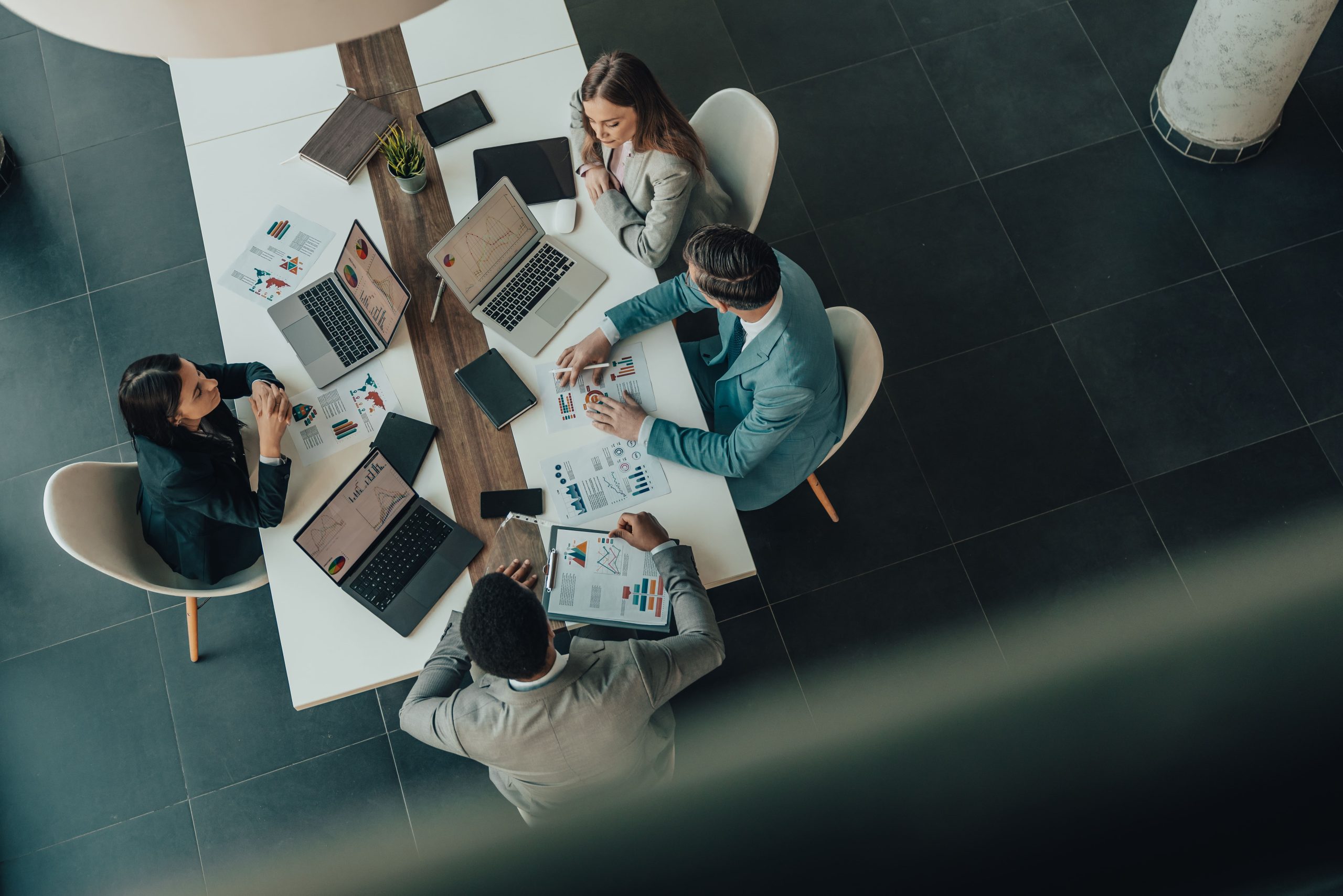 Business team reviewing charts and discussing strategy during a professional meeting.